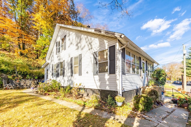 view of property exterior featuring a lawn