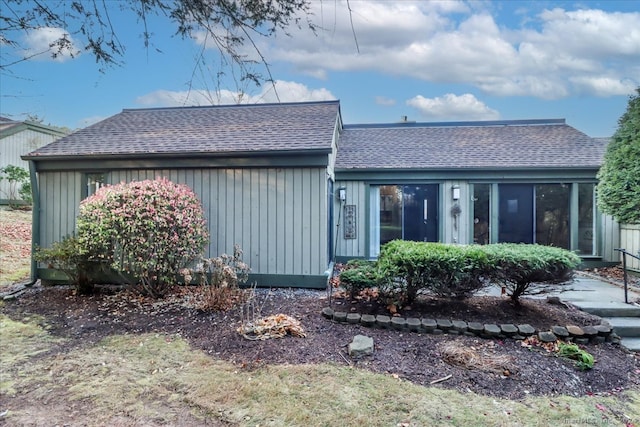 back of property with a sunroom