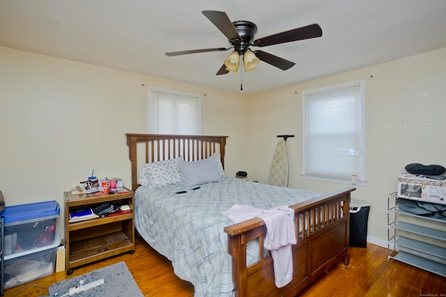 bedroom with ceiling fan and hardwood / wood-style floors