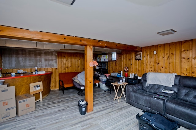 living room featuring light hardwood / wood-style flooring and wooden walls