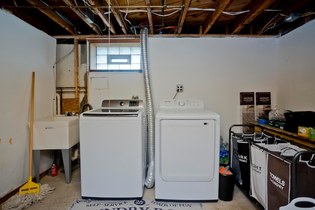 clothes washing area with sink and washing machine and clothes dryer