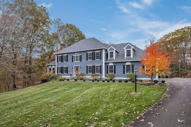 view of front of house featuring a front yard and a chimney