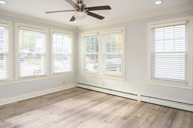 unfurnished room featuring a baseboard radiator, light hardwood / wood-style floors, and plenty of natural light