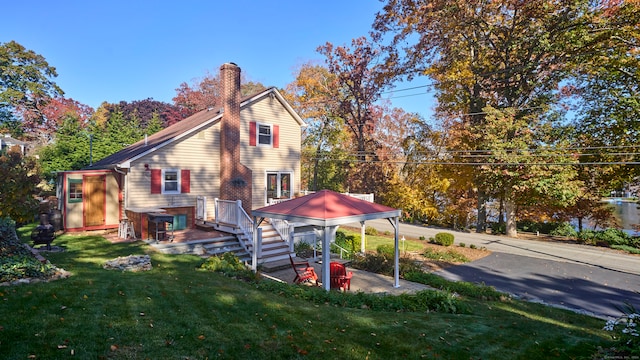 rear view of house featuring a yard