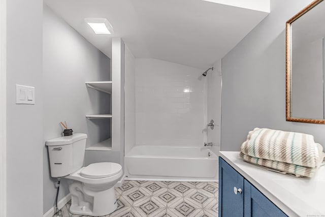 full bathroom featuring vanity, toilet, lofted ceiling, and tiled shower / bath