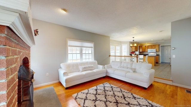 living room featuring light hardwood / wood-style floors and a chandelier