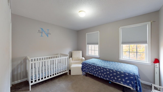 bedroom with a textured ceiling and carpet floors