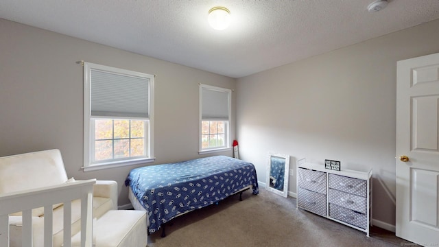 carpeted bedroom featuring a textured ceiling