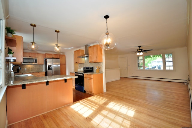 kitchen with wall chimney range hood, a baseboard heating unit, kitchen peninsula, light hardwood / wood-style floors, and appliances with stainless steel finishes