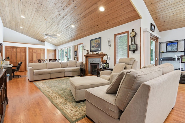 living area featuring high vaulted ceiling, light wood-style floors, wood ceiling, and a fireplace