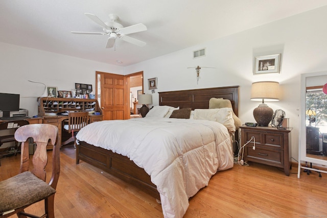 bedroom featuring light wood-type flooring, visible vents, and a ceiling fan