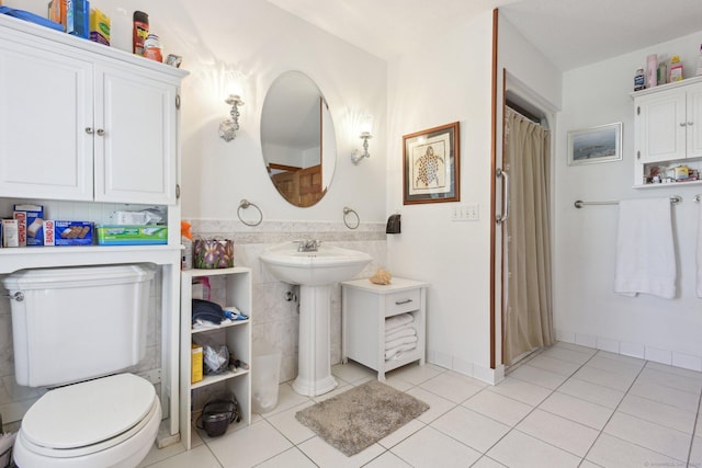 bathroom with tile patterned floors, curtained shower, and toilet