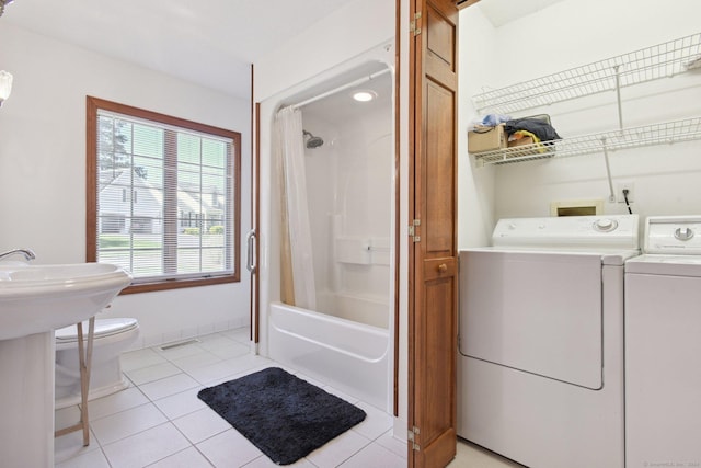 full bathroom featuring toilet, washing machine and dryer, shower / tub combo, tile patterned flooring, and baseboards