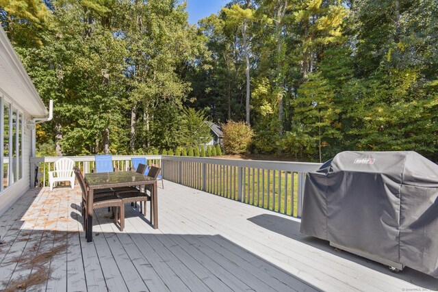 deck with outdoor dining area and area for grilling