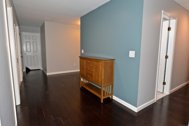 corridor with dark hardwood / wood-style flooring