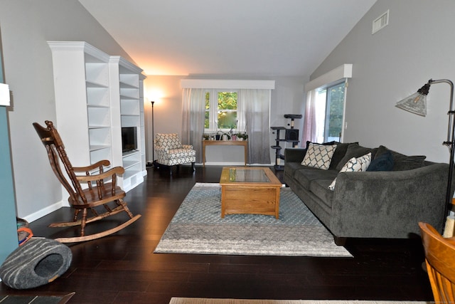 living room featuring lofted ceiling and dark hardwood / wood-style flooring