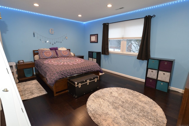 bedroom with dark wood-type flooring