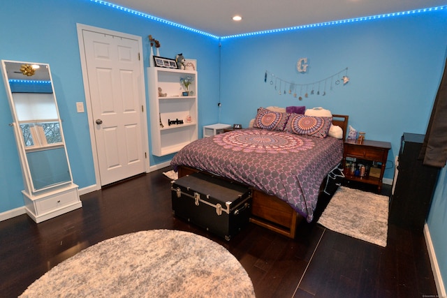 bedroom featuring dark hardwood / wood-style flooring