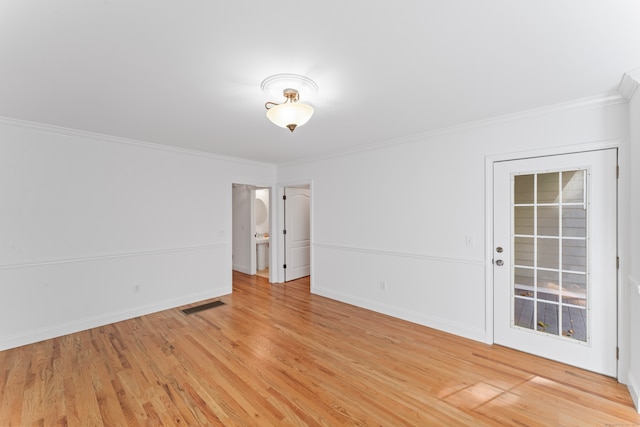 unfurnished room featuring light hardwood / wood-style floors and crown molding