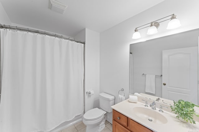 bathroom featuring walk in shower, tile patterned flooring, vanity, and toilet