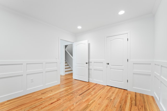 unfurnished bedroom featuring light hardwood / wood-style flooring and crown molding