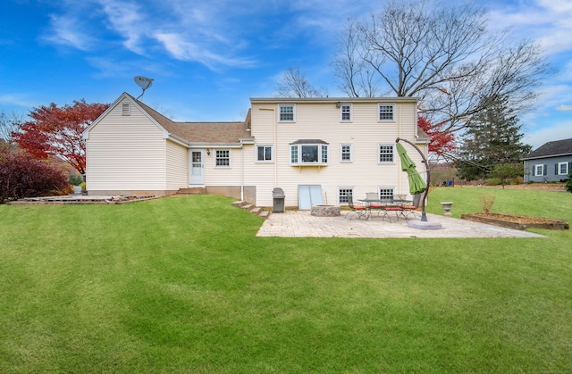 back of house featuring a patio and a lawn