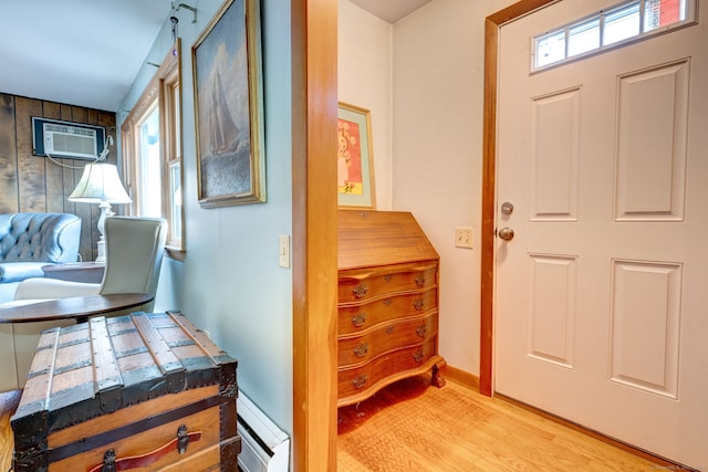 entryway with a wall mounted AC, a wealth of natural light, and light wood-type flooring