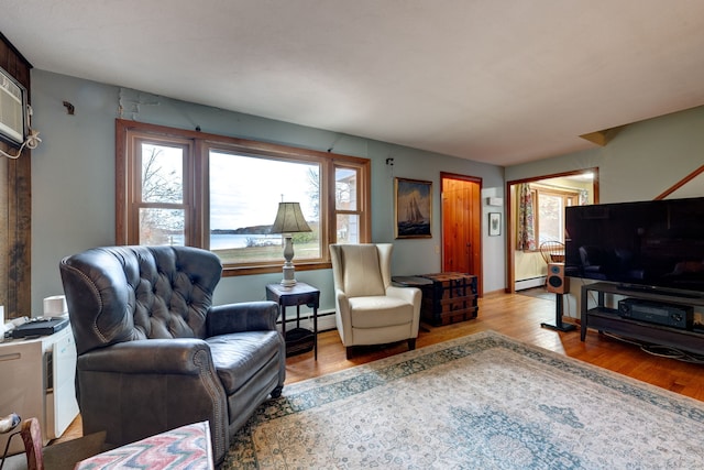 living room with light wood-type flooring and a baseboard radiator