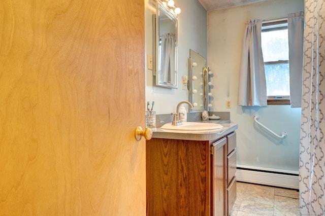 bathroom with tile patterned flooring, vanity, and a baseboard radiator