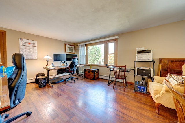 office space with a wall mounted air conditioner, wood-type flooring, and a baseboard heating unit