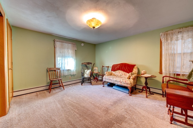 living area featuring carpet floors and a baseboard heating unit