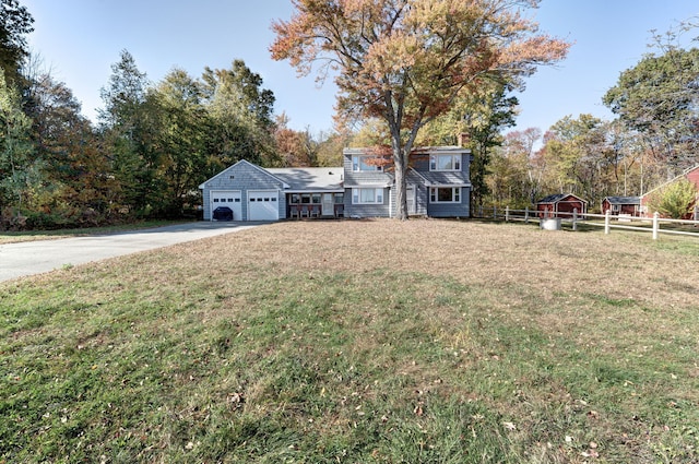 view of front of property featuring a garage and a front yard