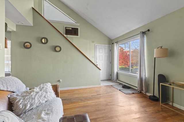 30 Merwin St Unit 6, Norwalk, CT 06850 - living room featuring a wall unit AC, wood finished floors, baseboards, stairs, and high vaulted ceiling