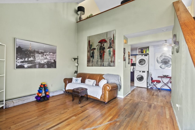 30 Merwin St Unit 6, Norwalk, CT 06850 - living area featuring estacked washer and dryer, wood finished floors, and a high ceiling