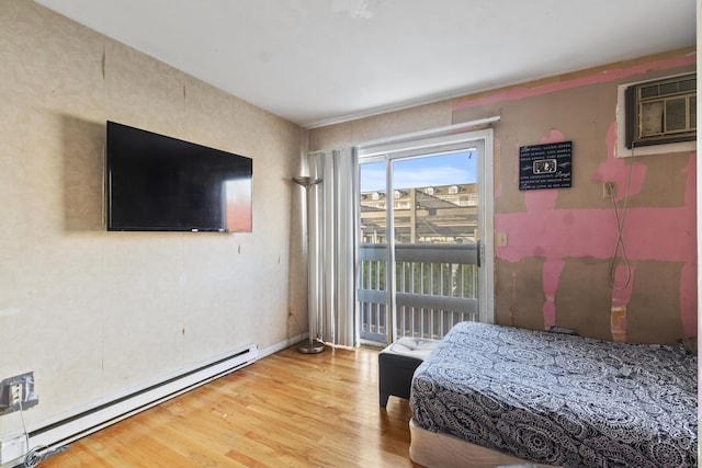 30 Merwin St Unit 6, Norwalk, CT 06850 - bedroom with baseboard heating, access to exterior, a wall unit AC, and wood finished floors