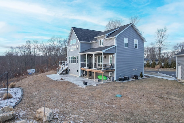 rear view of house featuring a deck and a sunroom