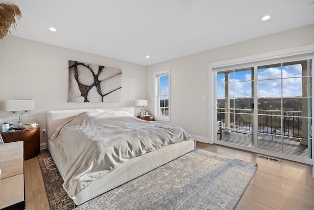 bedroom featuring access to exterior and light hardwood / wood-style flooring