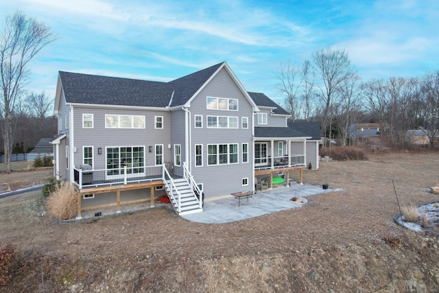 rear view of property with a patio area and a wooden deck