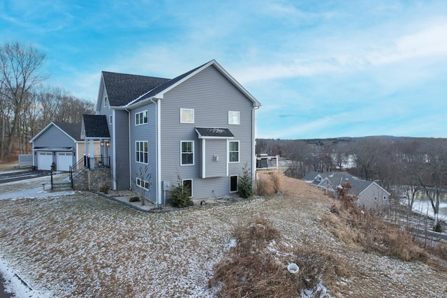 snow covered house with a garage