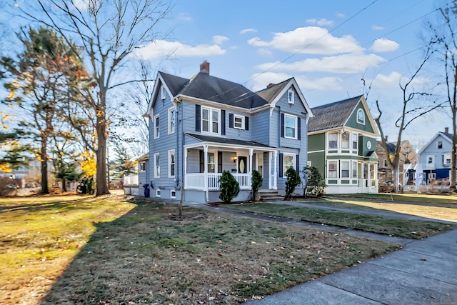 view of front of home with covered porch and a front yard