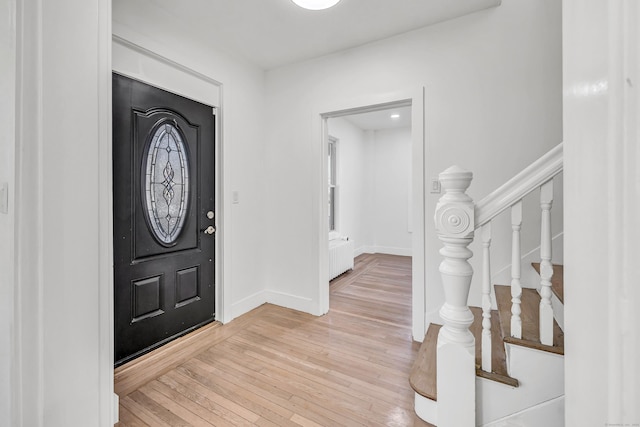 foyer featuring radiator heating unit and light wood-type flooring