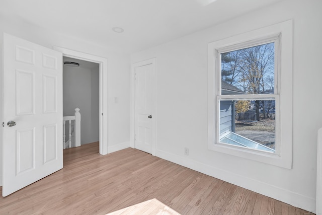 unfurnished bedroom featuring light hardwood / wood-style floors and multiple windows