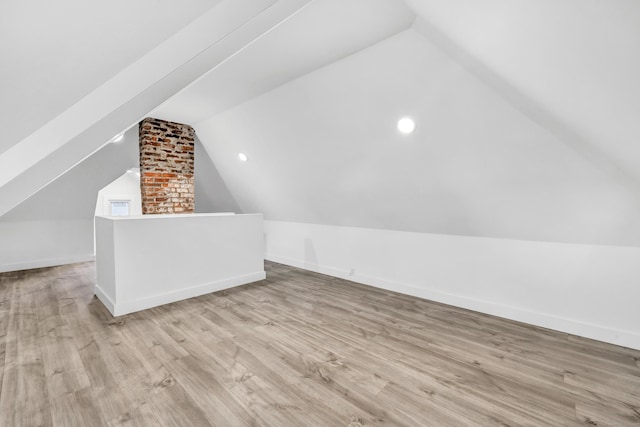 bonus room featuring light hardwood / wood-style floors and vaulted ceiling