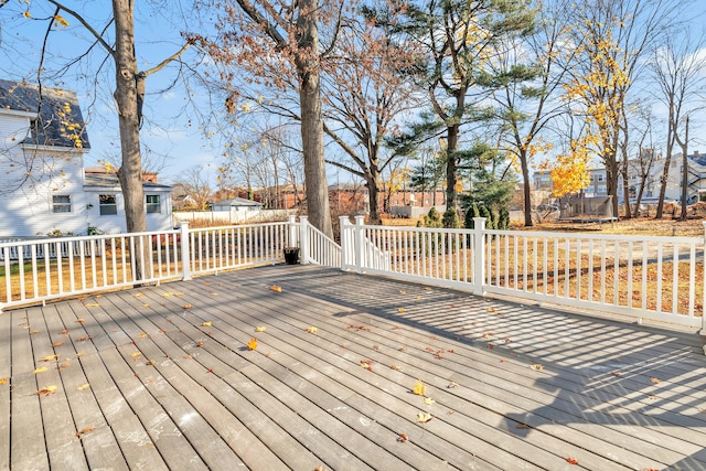 wooden terrace with a trampoline