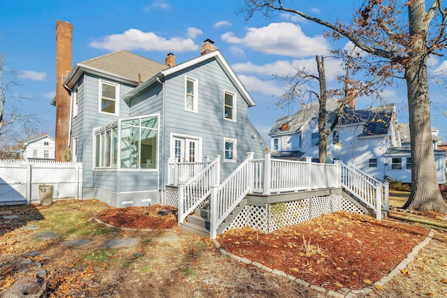 back of property with a wooden deck