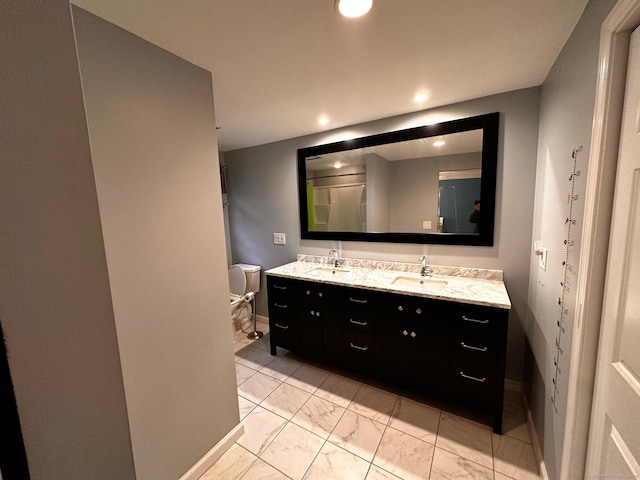 full bathroom featuring recessed lighting, a sink, toilet, and double vanity