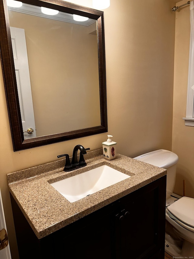 half bathroom featuring toilet and vanity