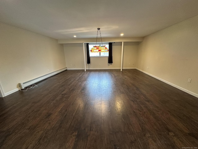 empty room featuring baseboards, baseboard heating, dark wood-type flooring, and recessed lighting