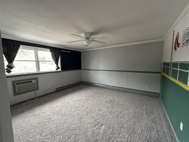 spare room with a textured ceiling, a wainscoted wall, a ceiling fan, a wall mounted air conditioner, and crown molding