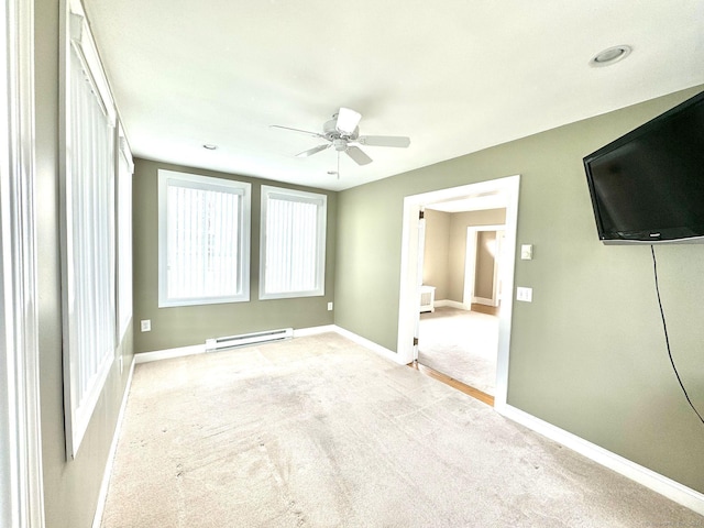 unfurnished bedroom with baseboard heating, light carpet, and ceiling fan